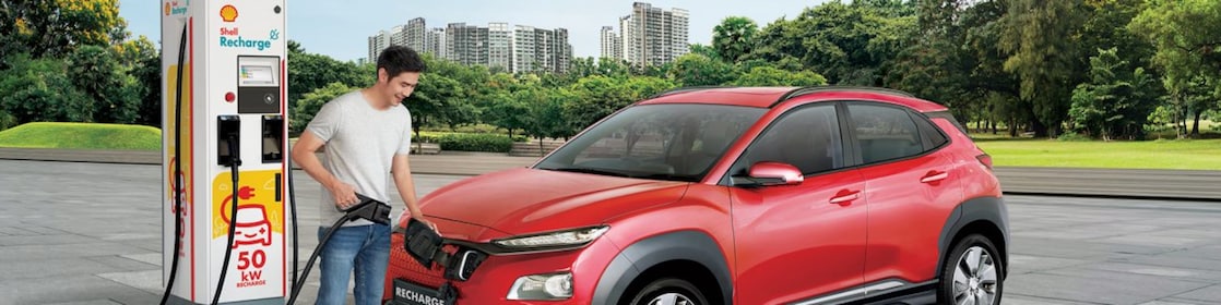 Man filling car at Shell recharge station