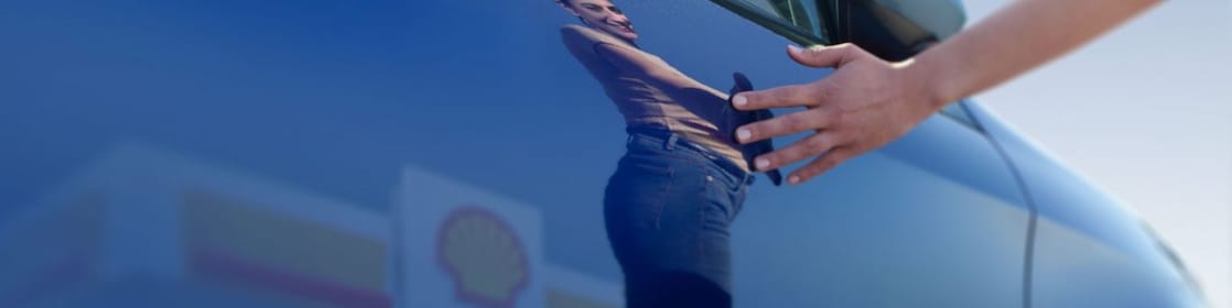 Woman with her car at a Shell retail station